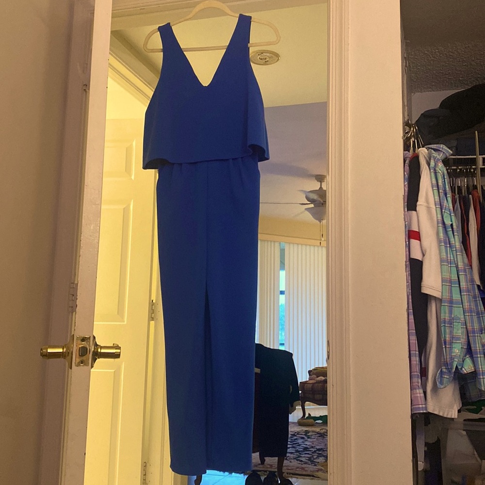 Women’s S blue one piece overalls with the zip up back and open like vest on top